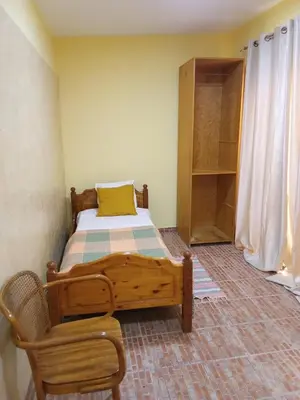 a bedroom with a wooden bed and a chair at sweet single in Santa Maria