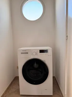 a washing machine in a room with a window at Sea view - Ca Mauro - Praia Cabral - Wi-Fi in Sal Rei