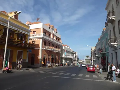 a city street with people crossing the street at Royal Mindelo Suite in Mindelo