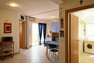 a kitchen and dining room with a table and chairs at Tommy's Apartment in Santa Maria