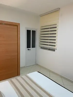 a bedroom with a bed and a window and a door at Casa Nela grand balcon vitré in Tarrafal