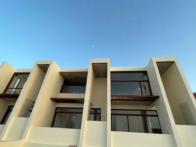 an apartment building with balconies against a blue sky at Walhalla Seahouse in Chã da Igreja