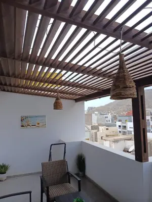 a patio with a wooden ceiling and a table and chairs at Apartamento Moderno in Mindelo