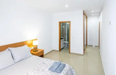 a bedroom with a bed and a bathroom at Apartamentos Modernos Santo Antão in Ribeira Grande