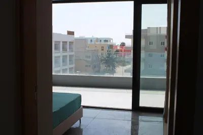 a room with a window with a view of a city at APARTAMENTO T2 - SAL REI - Boa Vista in Sal Rei