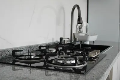 a black stove top oven in a kitchen at APARTAMENTO T2 - SAL REI - Boa Vista in Sal Rei