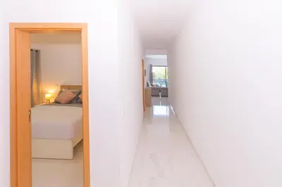 a hallway leading to a bedroom with a bed at Brand New Spacious T3 Apartment in Santa Maria in Santa Maria
