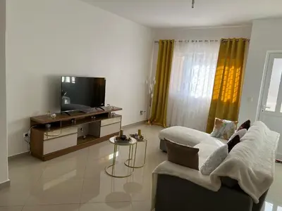 a living room with a couch and a flat screen tv at DMSilva in Praia