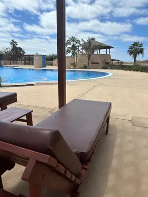 a bench in front of a swimming pool at Tropical Paradise in Santa Maria