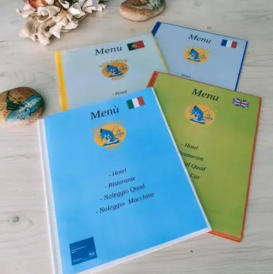 a selection of menu cards on a table at Pensão Big Game Maio Vila do Maio in Vila do Maio