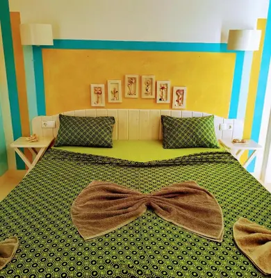 a bedroom with a large bed with a bow on it at Pensão Big Game Maio Vila do Maio in Vila do Maio