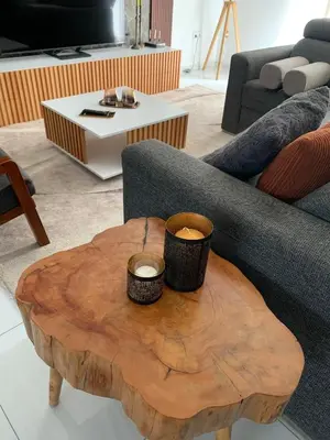 a wooden coffee table with two cups on top of it at Alfa-apartamento in Pombas