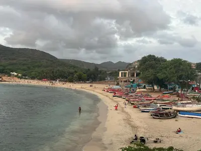 a beach with a bunch of boats on it at Techas Stylish 2-Bedroom 8 min to Beach in Tarrafal