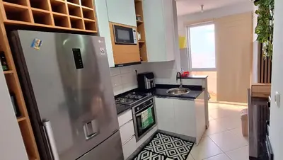 a kitchen with a refrigerator and a sink at Sinta-se em casa! in Praia