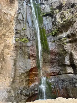 a waterfall on the side of a rock wall at Casa Branca in Ponta do Sol