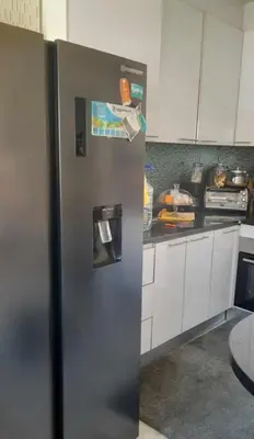 a stainless steel refrigerator in a kitchen at Apartamento Mi in Praia