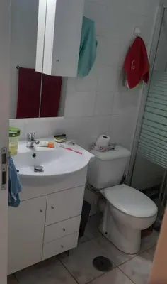 a bathroom with a white sink and a toilet at Apartamento Mi in Praia