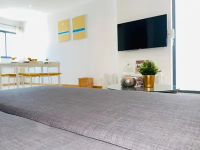 a bedroom with a large bed with a tv on the wall at Sal Little Heart Apartment 21 in Santa Maria
