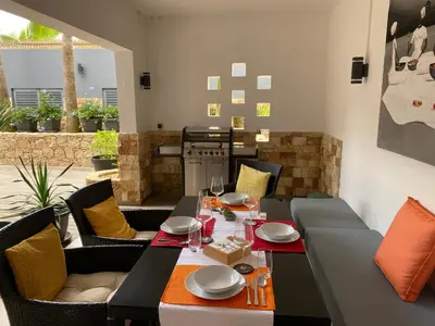 a dining room with a table and chairs at Zweite Heimat - Townhouse Boa Vista in Sal Rei