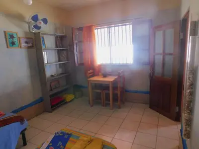 a room with a table and a window and a door at Tortuga B&B in São Filipe