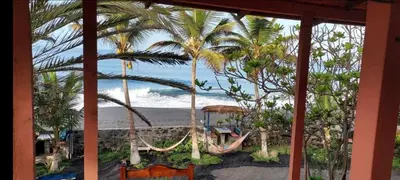 a view of the beach from a resort with hammocks at Tortuga B&B in São Filipe