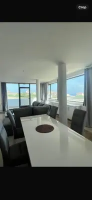 a living room with a white table and chairs at Casa Monte Cara T2 in Lazareto