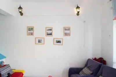 a living room with a couch and pictures on the wall at Mendes Family Guesthouse, and Services in Praia