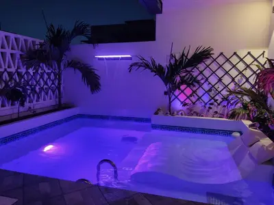 a pool with purple lights in a room with plants at Luxury Paradise Beach Lagoon in Sal Rei