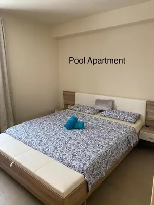 a bedroom with a bed with blue pillows on it at Luxury Paradise Beach Lagoon in Sal Rei