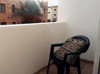 a black chair with a pillow sitting on a balcony at My Boavista 1 in Sal Rei