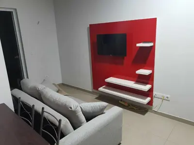 a living room with a couch and a tv at Elizabeth Rocha in Mindelo