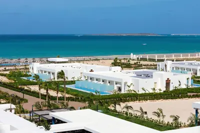 an aerial view of a beach with white buildings and the ocean at Hotel Riu Palace Boavista - All Inclusive in Boa Ventura