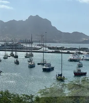 a group of boats sitting in the water at Apartamento Baia Marginal 2 in Mindelo
