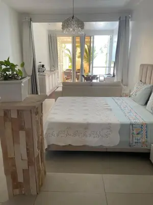 a bedroom with a bed and a large window at Villa Alfredo Marchetti 13B in Cabeçadas