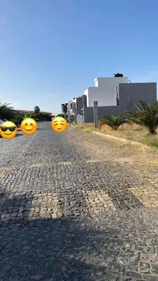 three yellow pumpkins are sitting on a cobblestone street at Apartamento Casa Sabi in Praia