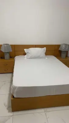 a bedroom with a bed with two lamps on it at Apartamento Casa Sabi in Praia