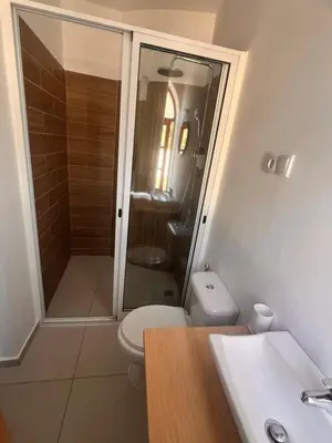 a bathroom with a shower and a toilet and a sink at Bed and breakfast Residencial Maravilha in Mindelo