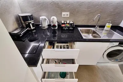 a kitchen with a sink and a counter top at Apartamentos Golfinho Dourado `Edifício Lux,s in Santa Maria