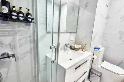 a bathroom with a shower and a sink and a toilet at Apartamentos Golfinho Dourado `Edifício Lux,s in Santa Maria