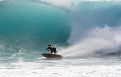 a person riding a wave on a surfboard in the ocean at Casa Bahia 4 in Santa Maria