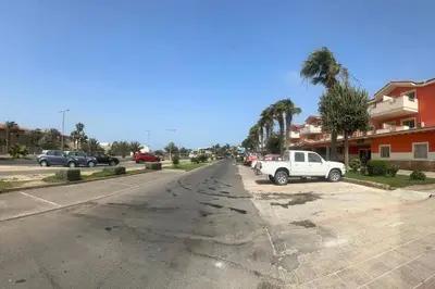 an empty street with a white truck parked in a parking lot at appartement by seb in Santa Maria