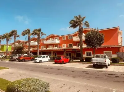a parking lot with cars parked in front of a building at appartement by seb in Santa Maria