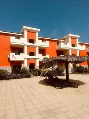 a building with an umbrella and chairs in front of it at appartement by seb in Santa Maria