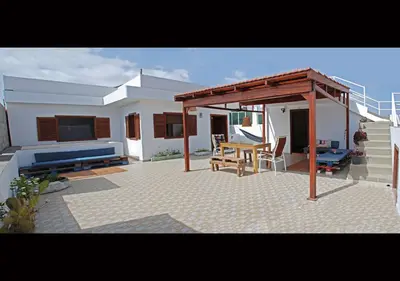 a patio with a table and a pavilion at Self-catering Apartment w/ Terrace in Tarrafal