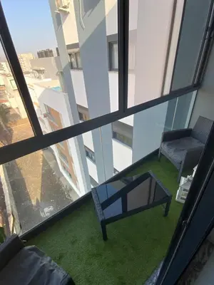 a room with a table and a chair in a building at Felicidade apartamento Palmarejo Grande in Praia