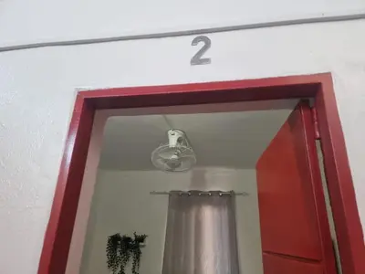 a mirror with a red frame and a light over a door at Casa Cisalta N2 - 5mn Centro City in Praia