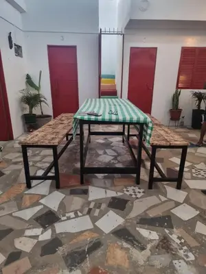 a table and two benches in a room at Casa Cisalta N3 - Quarto 5mn CENTER CITY in Praia
