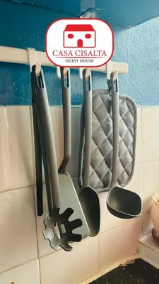 a rack of cooking utensils hanging on a wall at Casa Cisalta N5 - Quarto Casal in Praia