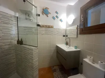 a bathroom with a shower and a toilet and a sink at Porto Antigo 2 studio 15 beach and pool in Santa Maria