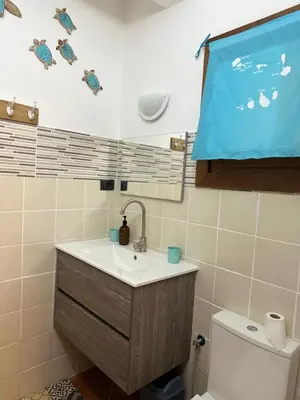 a bathroom with a sink and a large screen at Porto Antigo 2 studio 15 beach and pool in Santa Maria
